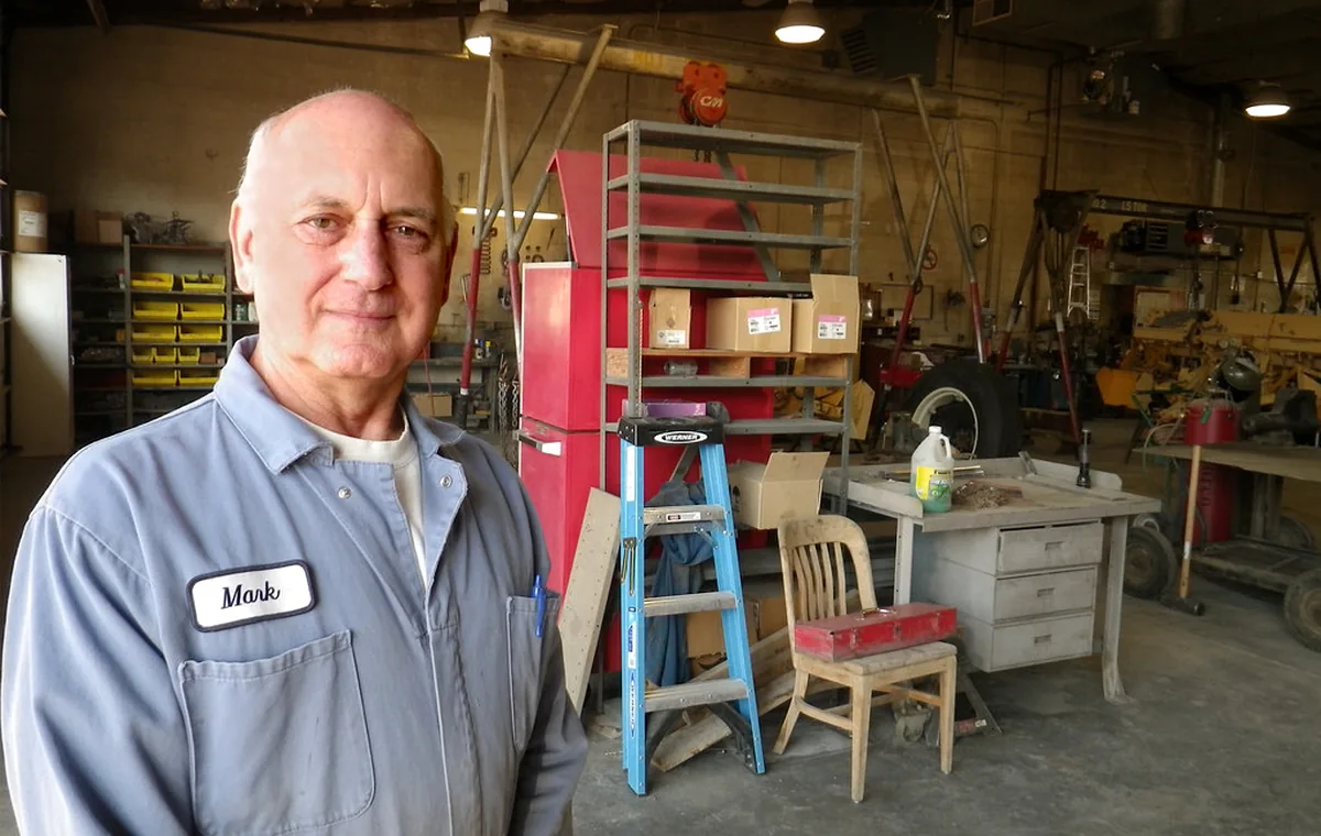 Service team preparing agricultural machinery in a workshop