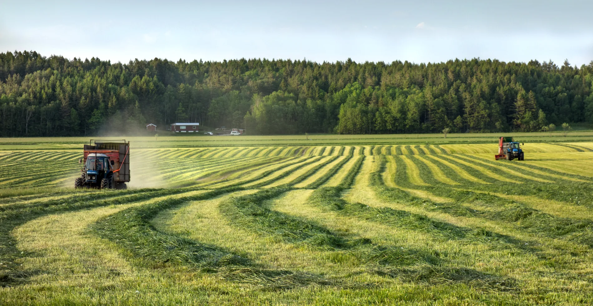 Tractor and field equipment working across a large agricultural field