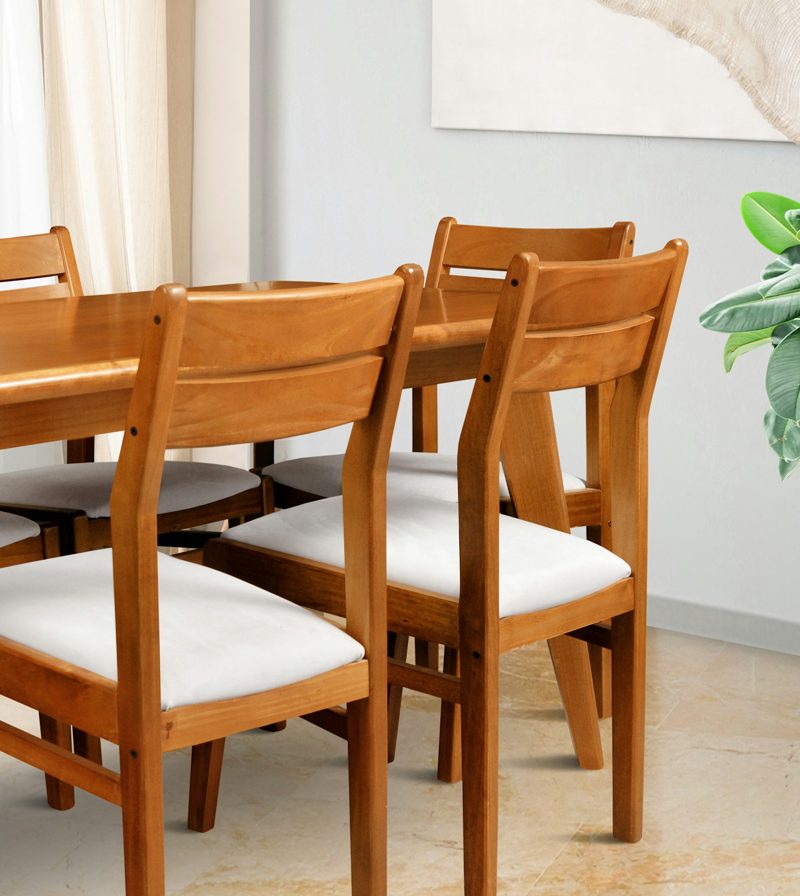 Wood dining chairs with light cushions around a table